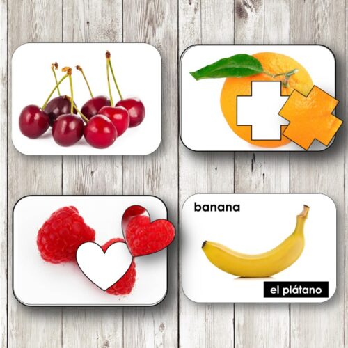 Fruits and Berries Toddler Picture Cards feature four cards showing cherries, orange, raspberries, and banana, each with a shape overlay and English-Spanish labels—ideal for teaching toddlers about fruits and berries. Montessori Nature Printables