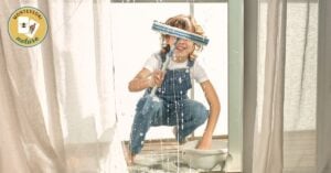 In this practical life activity, a child is using a mop to clean and prepare the window. This simple task of cleaning not only teaches them about hygiene but also helps develop coordination and concentration skills