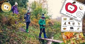 A group of children are walking on a wooden bridge in the woods.