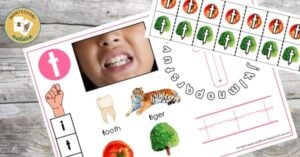 A picture of a child's teeth and pictures on a wooden table.