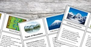 Several educational flashcards are spread out on a wooden surface, showing images and definitions of river landforms and types of mountains—perfect for hands-on science activities. Montessori Nature Printables