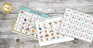 A set of animal bingo cards on a wooden table.