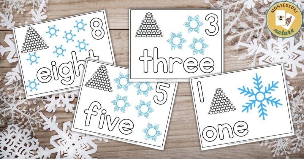 Four snowflake cards with numbers on them.