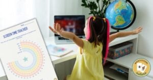 A little girl is standing in front of a poster with a globe on it.