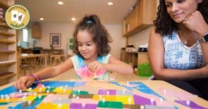 In a Montessori classroom, a young girl is enthusiastically building structures with blocks while learning new lessons from her teacher.
