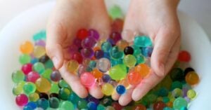 child holding beads in hands
